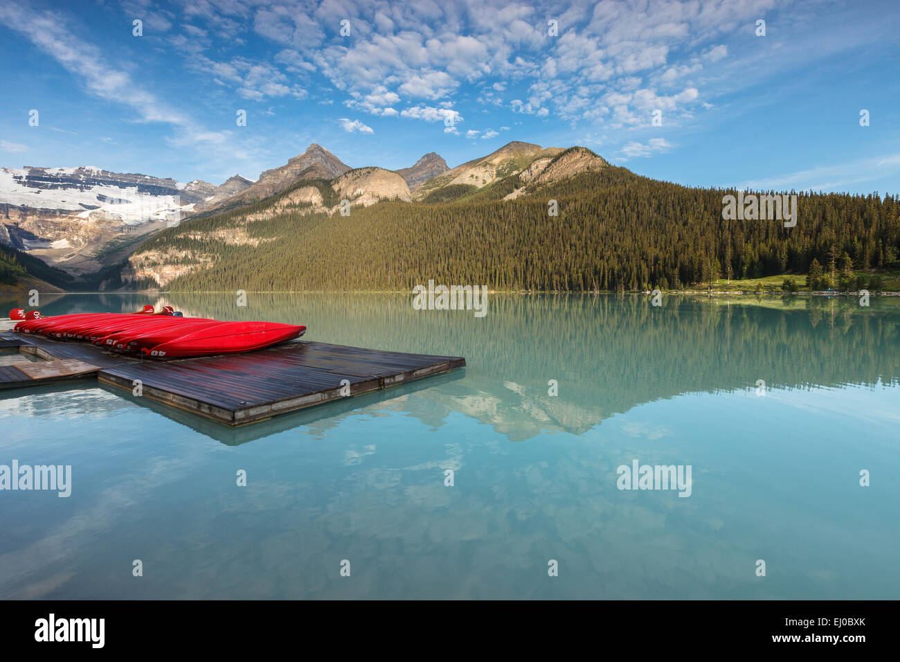 Red Canoes at Lake Louise by sunrise, Banff National Park, Alberta, Canada, America. Stock Photo