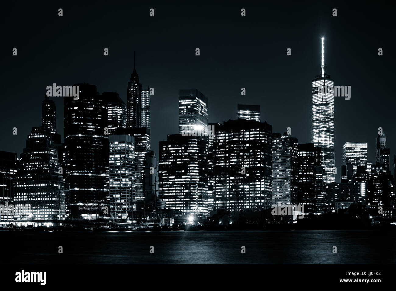 The Manhattan Skyline at night, seen from Brooklyn Bridge Park, Brooklyn, New York. Stock Photo