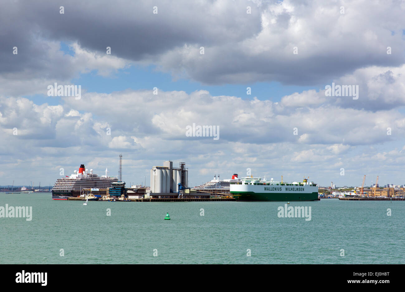 Southampton Docks With Big Cruise Ship And Cargo Vessel On Calm Summer Day With Fine Weather Blue Sky And White Clouds Southampton Docks With Big Cruise Ship And Cargo Vessel On Calm Summer Day With Fine Weather Blue Sky And White Clouds