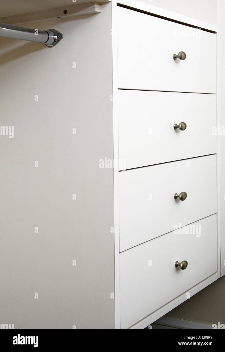 A Modern Bedroom Closet With Rods And Drawers Built In Stock Photo