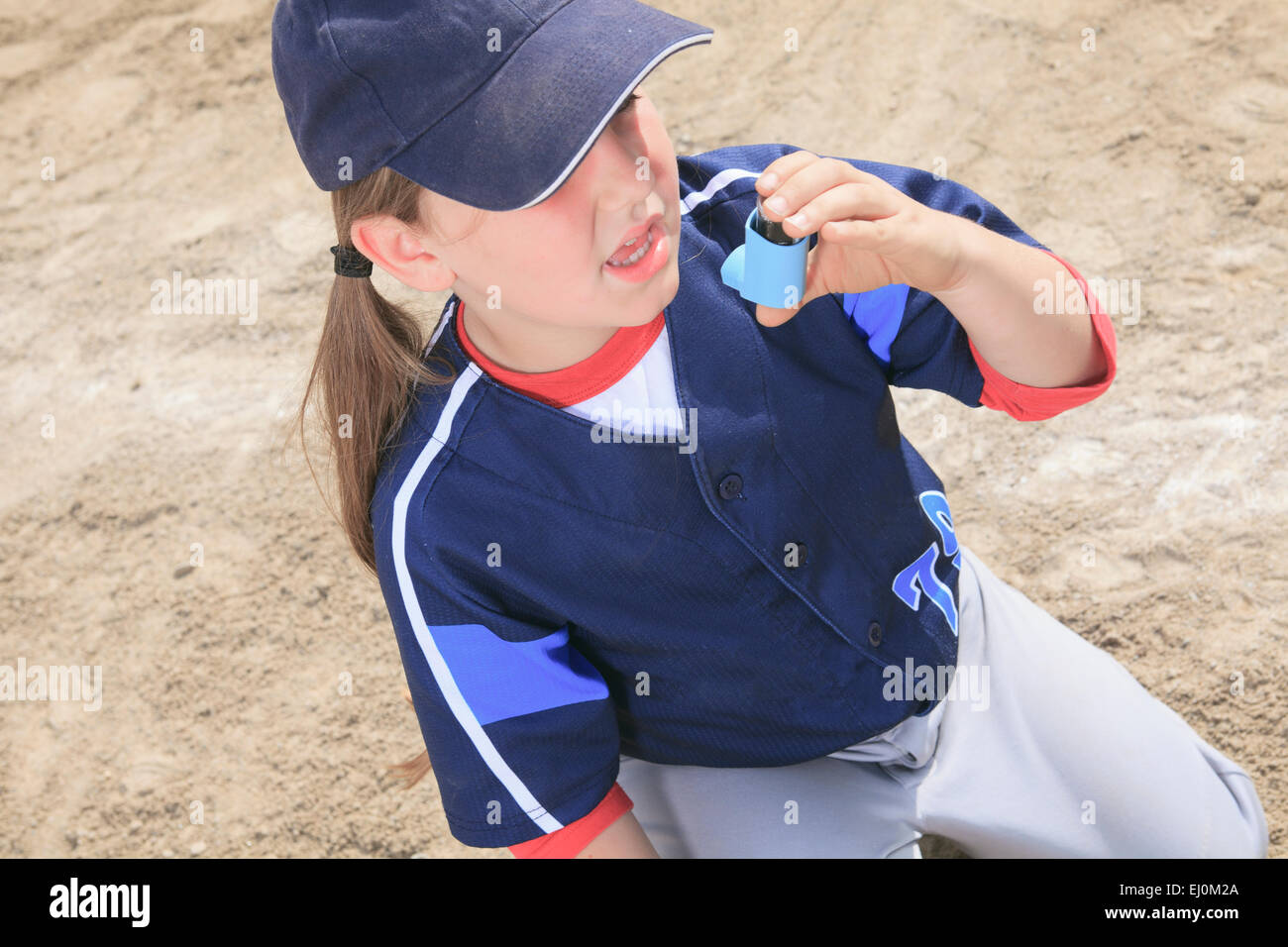 A baseball player having a asthma crisis Stock Photo