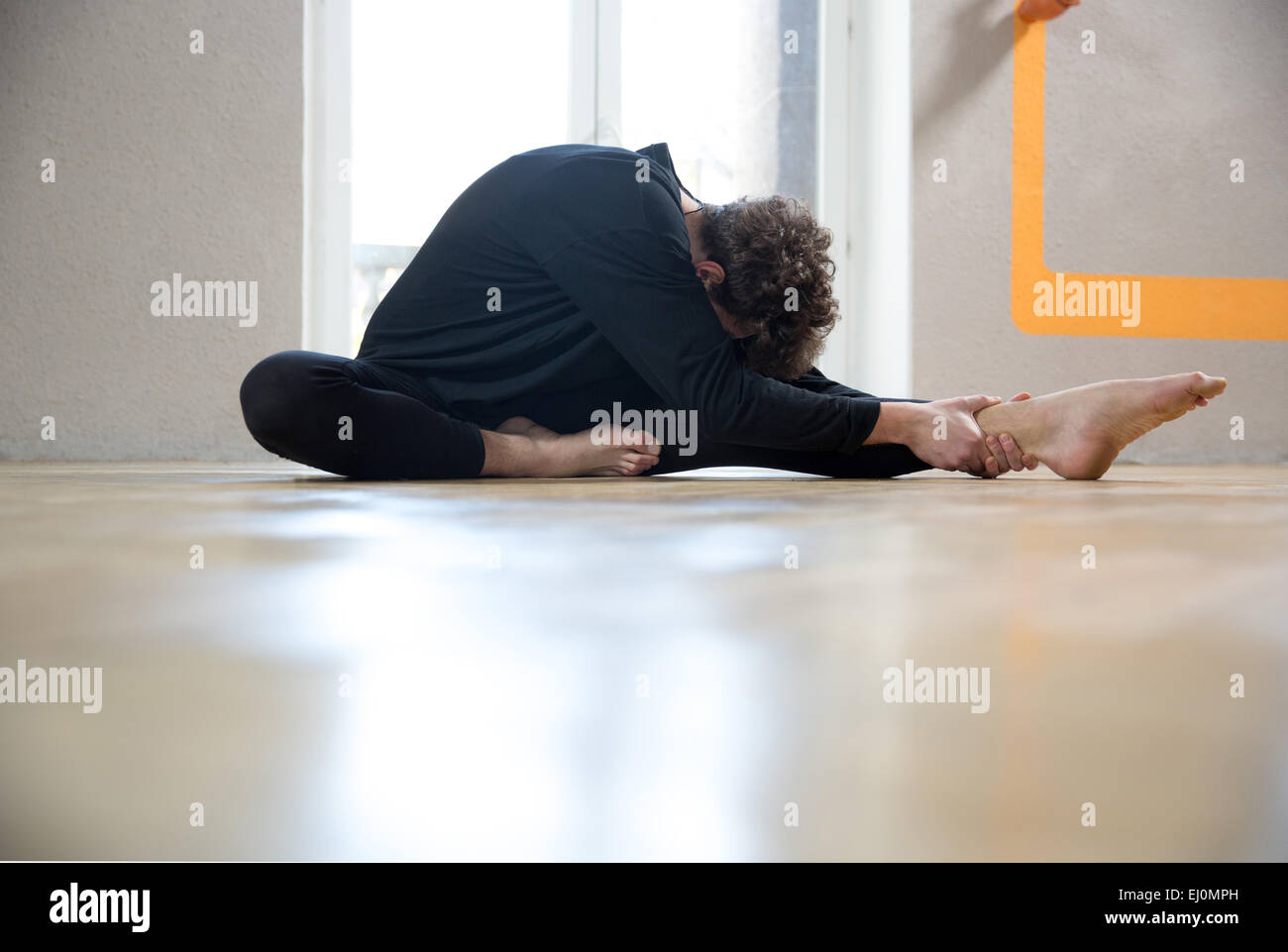 Man stretching floor legs hi-res stock photography and images - Alamy