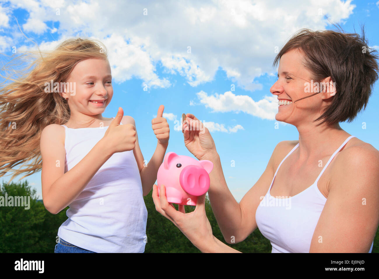 Piggy Bank and Coin holding by a little girl Stock Photo - Alamy