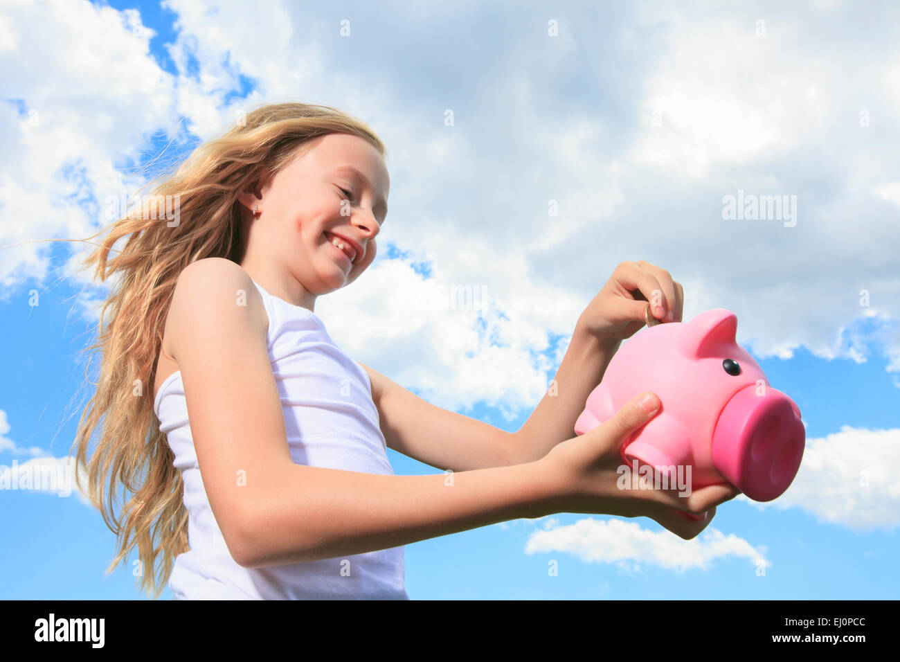 Piggy Bank and Coin holding by a little girl Stock Photo - Alamy