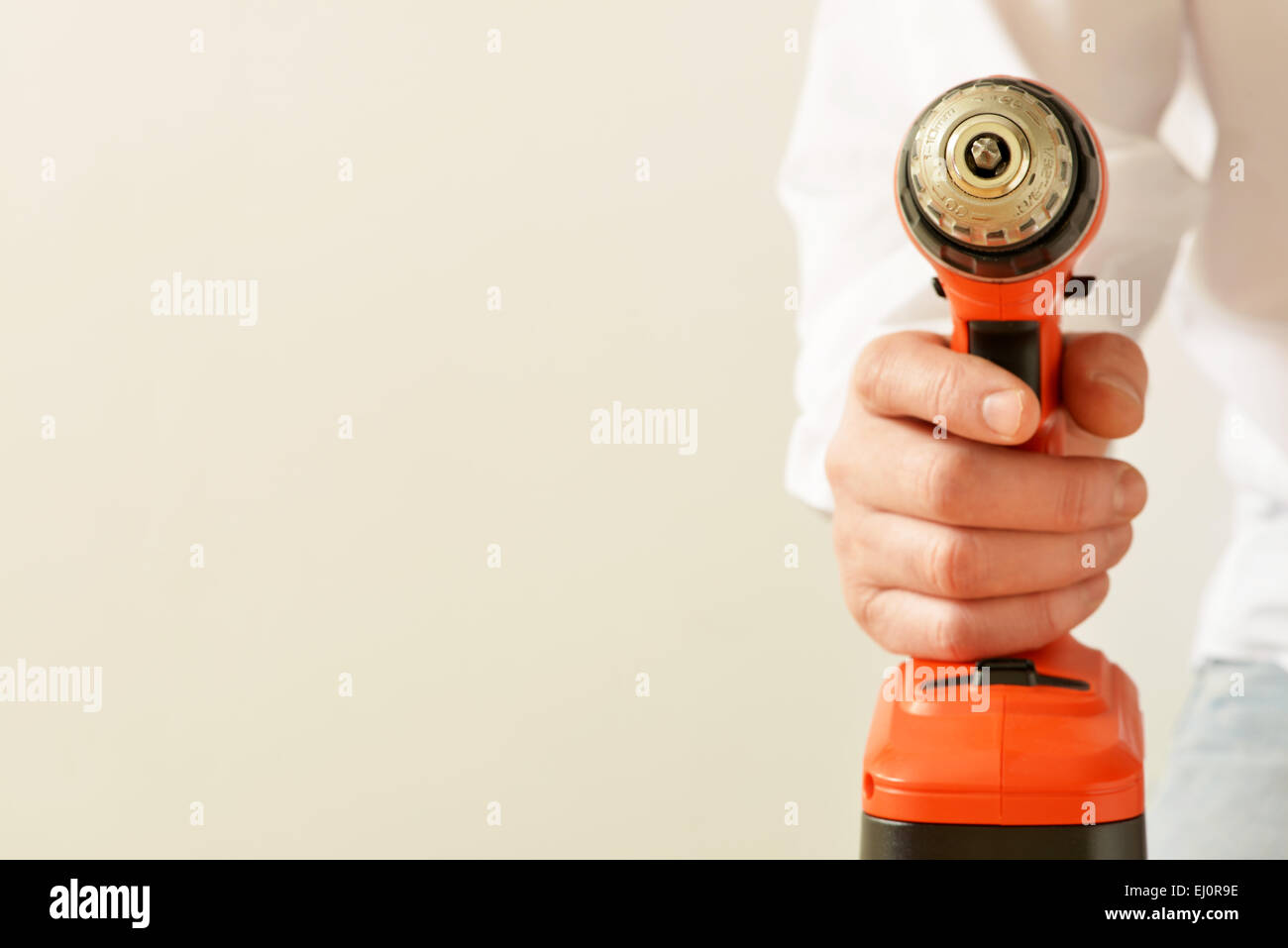 A battery powered screwdriver being held by a man Stock Photo