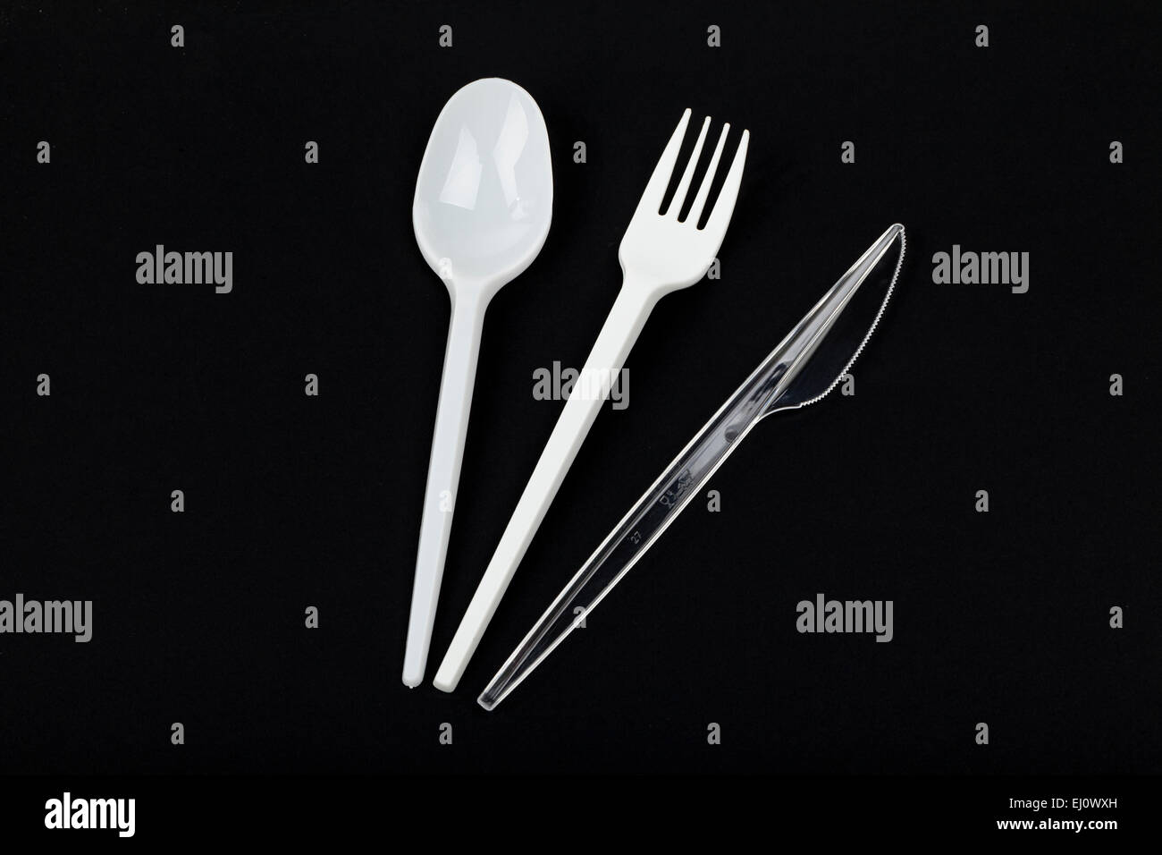 plastic cutlery on black background Stock Photo