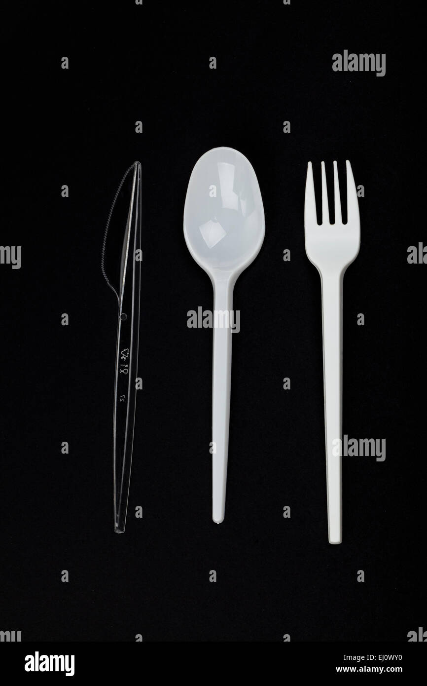 plastic cutlery on black background Stock Photo