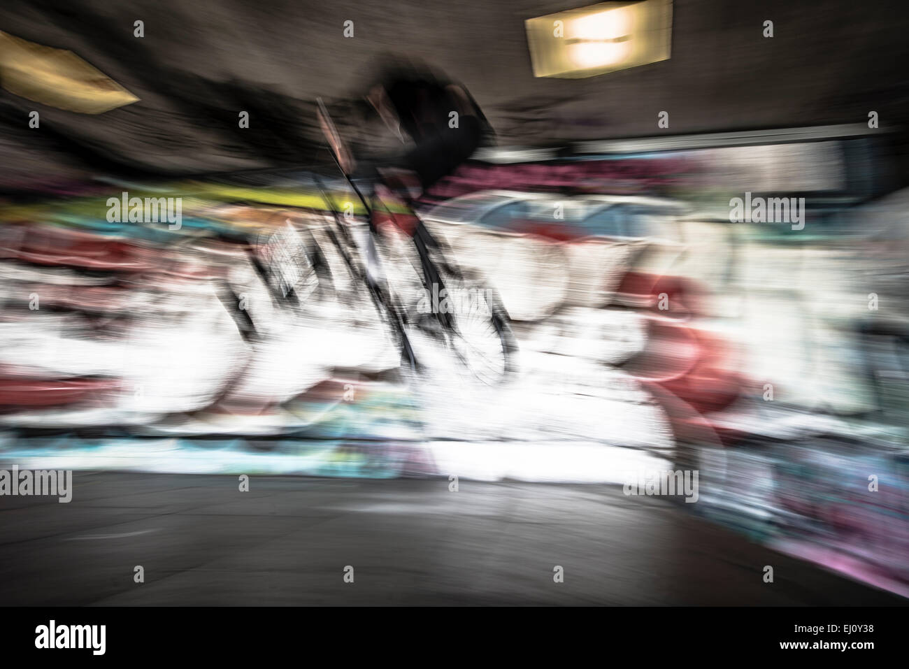 Stunt biker against graffiti wall Stock Photo