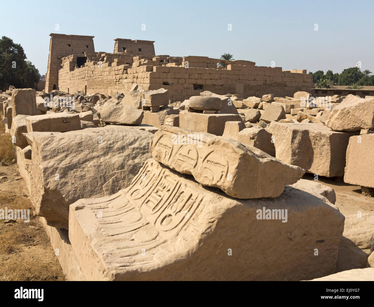 View over magazines of broken blocks to the Temple of Khonsu at the Temple of Karnak, Luxor Egypt Stock Photo