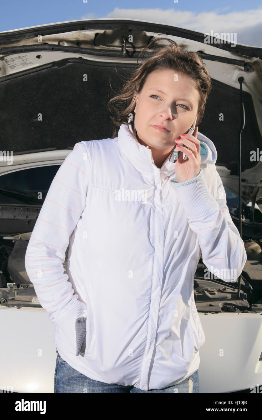 A woman who have a problem with is car Stock Photo