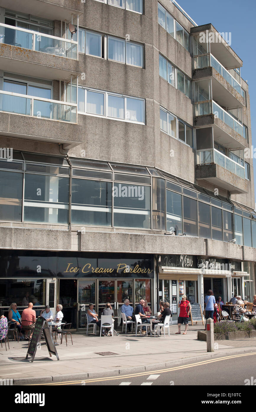 1960s flats above ice cream parlor and shops near sea front in coastal town of Folkestone, Kent, England, United Kingdom Stock Photo
