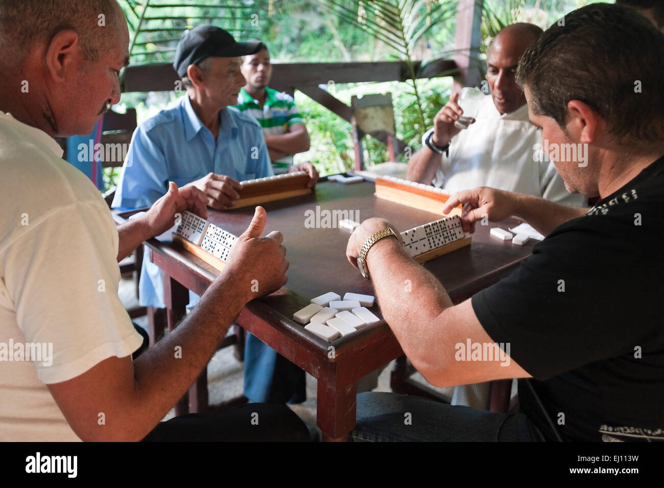 Horizontal view of a game of dominoes being played in Cuba. Stock Photo
