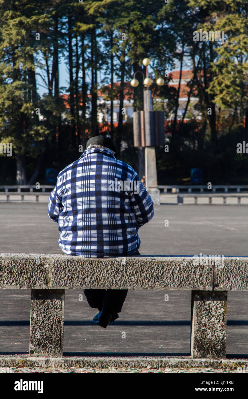 Old man sitting on stone park bench hi-res stock photography and images ...