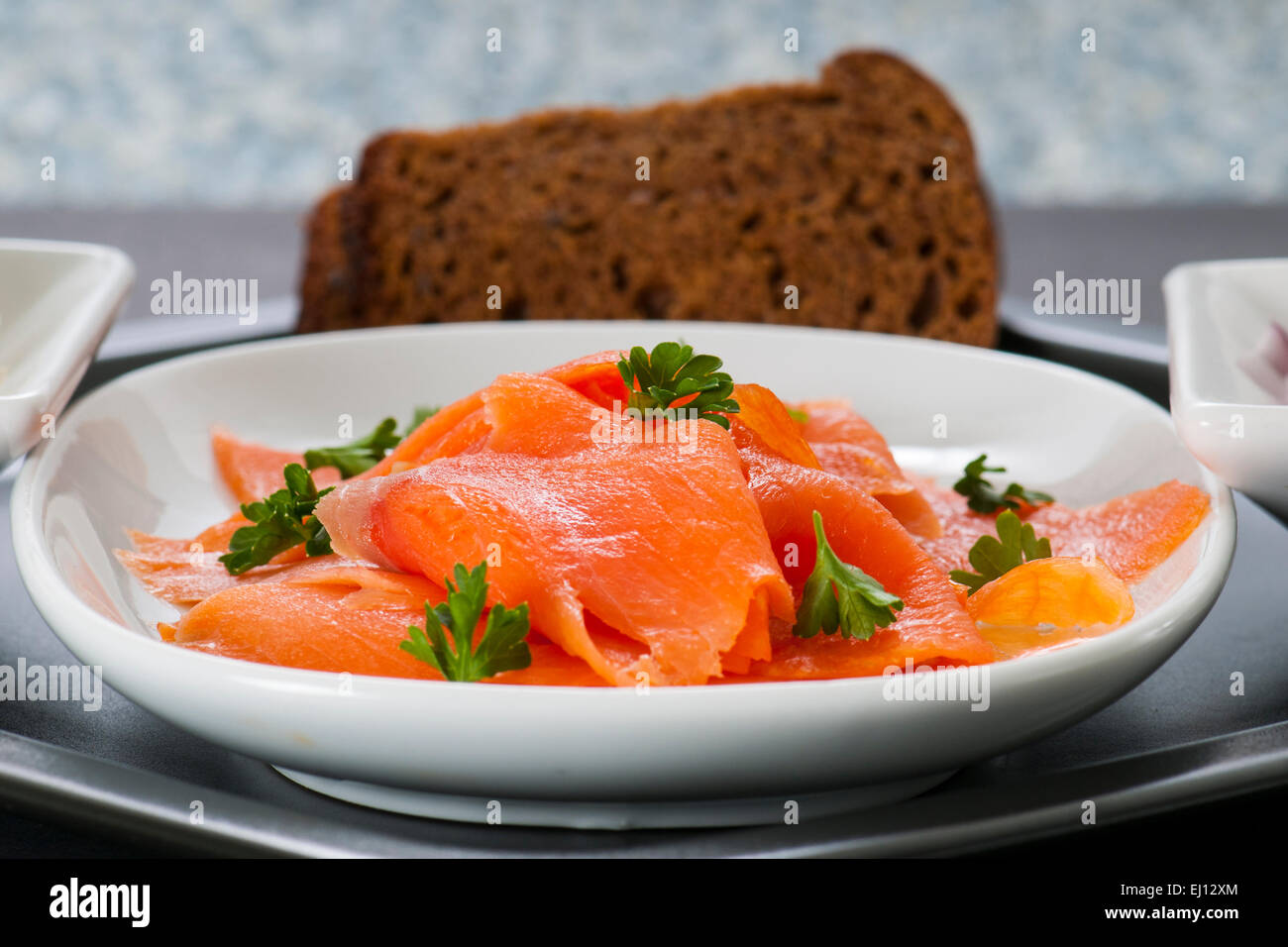 Smoked Salmon Lox platter with red onion, rye bread, and cream cheese
