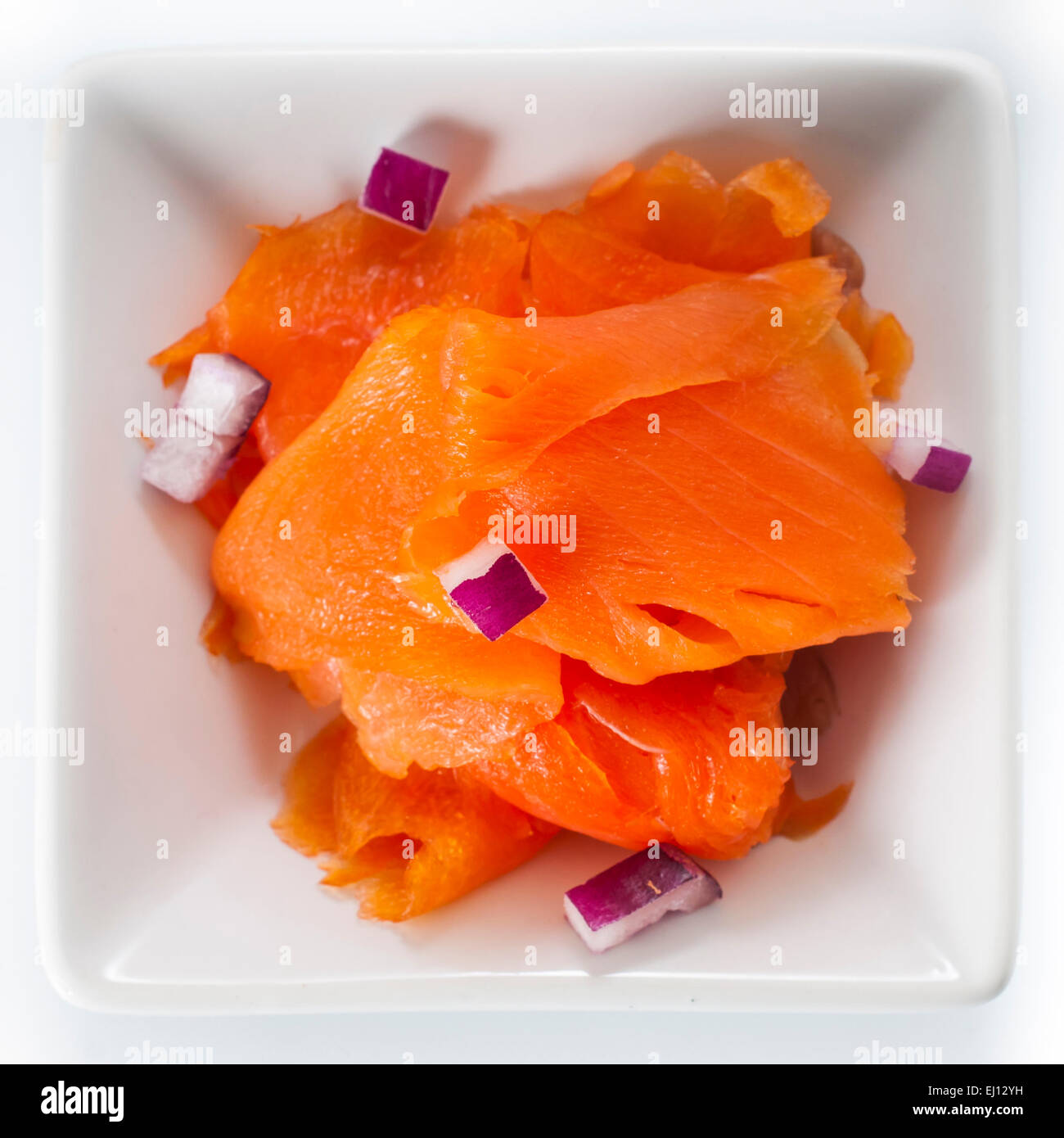 Dish of fine sliced smoked salmon lox and purple onions Stock Photo Alamy