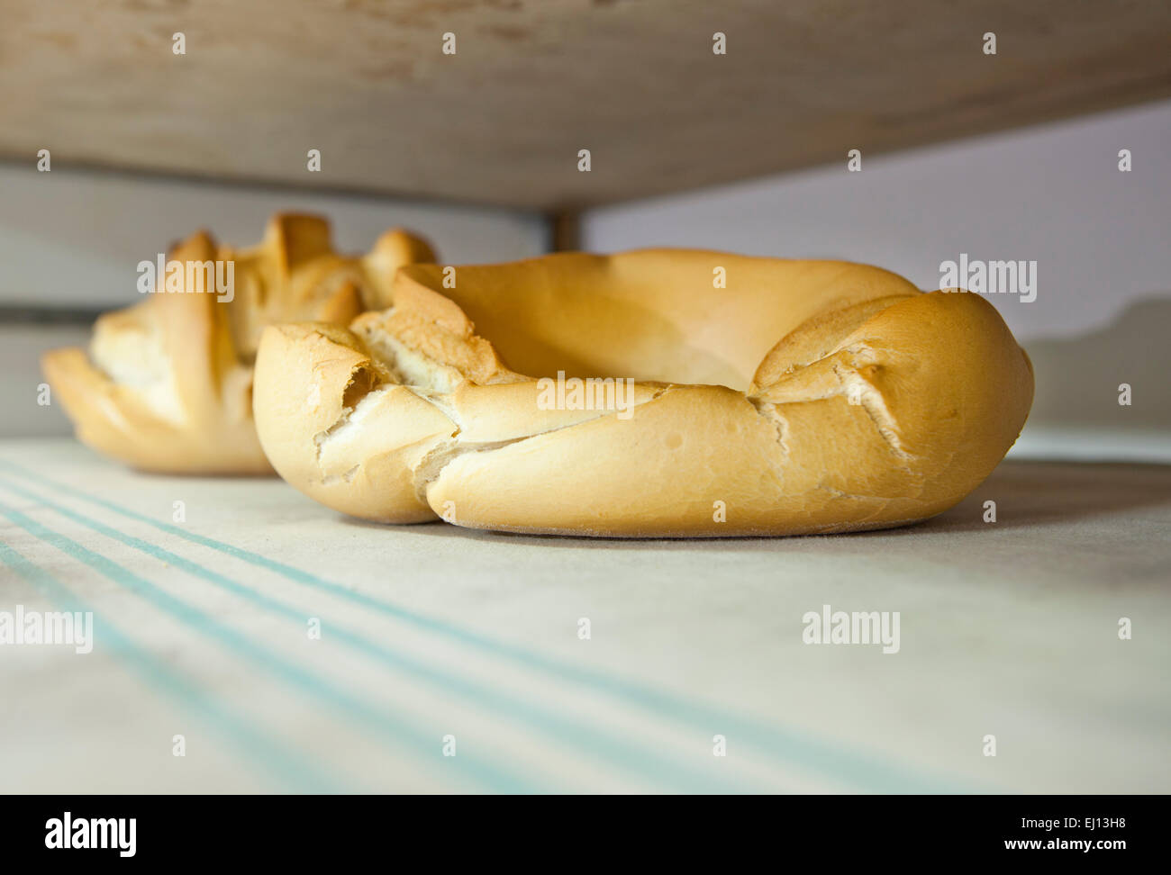 Doughnut fresh baked bread. Manufacturing process of spanish bread Stock Photo