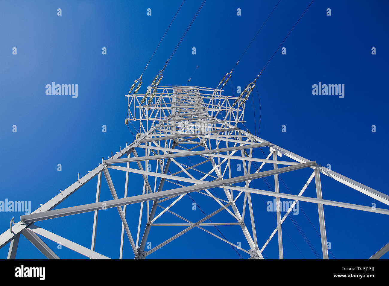 Electric power lines on a blue sky background Stock Photo - Alamy