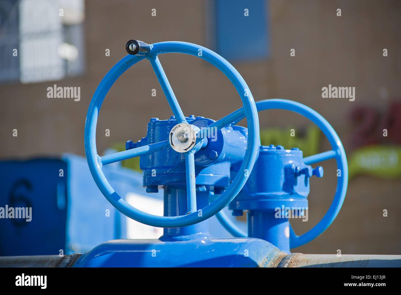 Blue large handwheels on a pipeline valves Stock Photo - Alamy