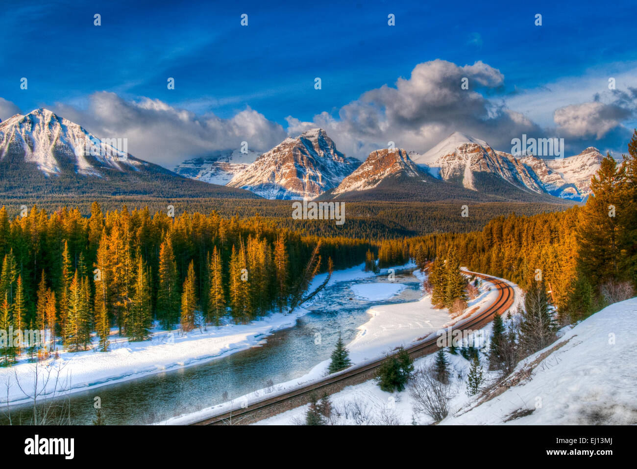 Scenic Morant's Curve on the Canadian Pacific Railway running along the Bow river in winter, Banff National Park, Alberta Canada Stock Photo
