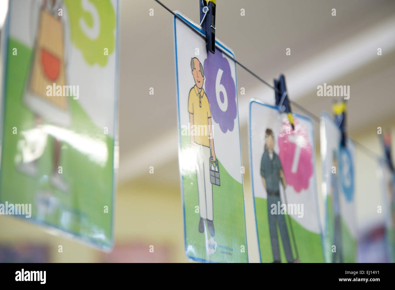 Number cards hanging in a UK classroom to help with numeracy Stock Photo
