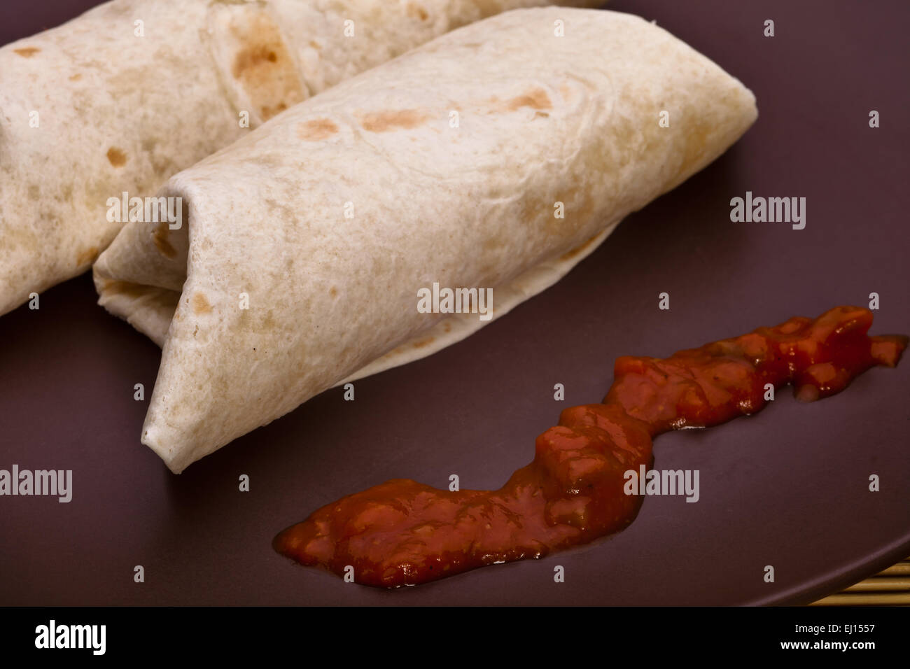Burritos with chicken pepper onion garlic and sauce Stock Photo Alamy