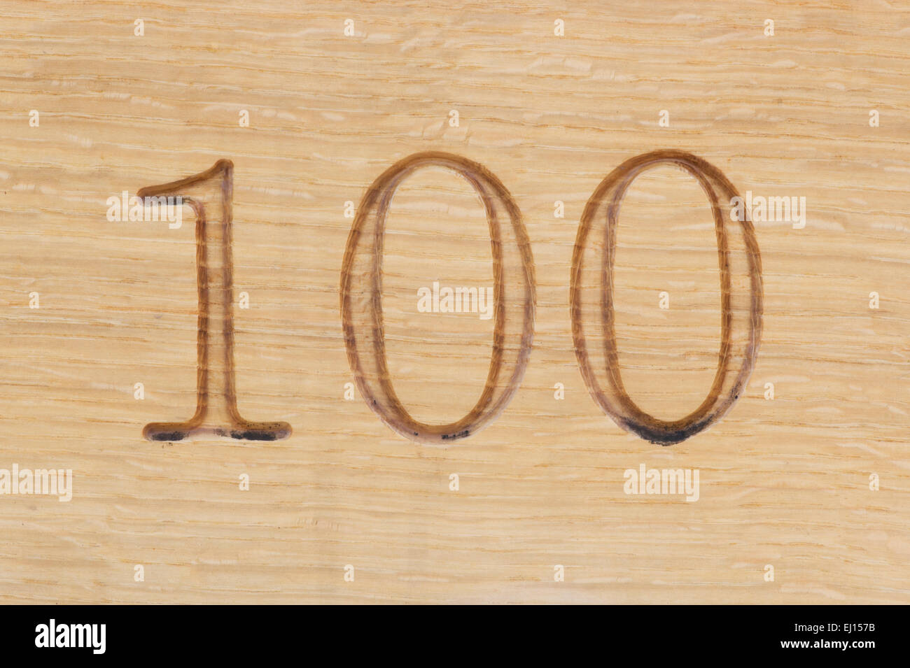 Number 100 carved into wood Stock Photo