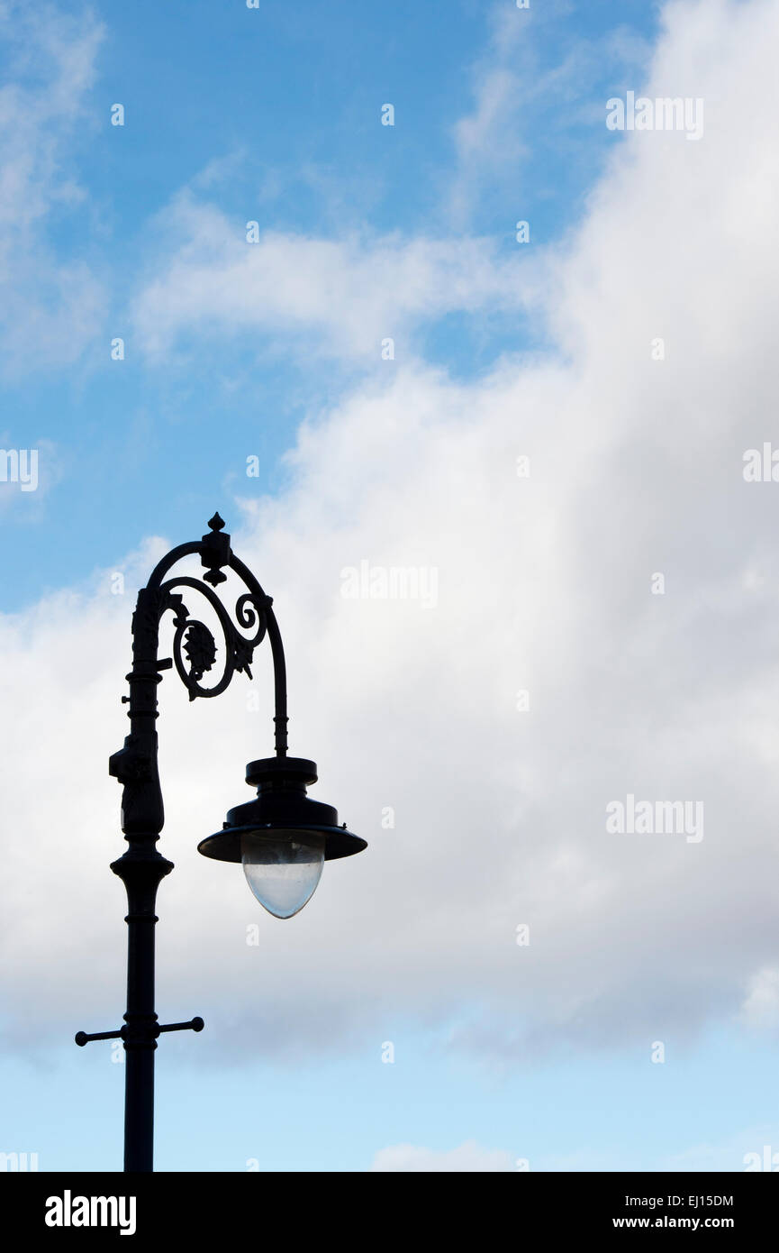 Ornate street lamp against a cloudy blue sky. Scotland Stock Photo