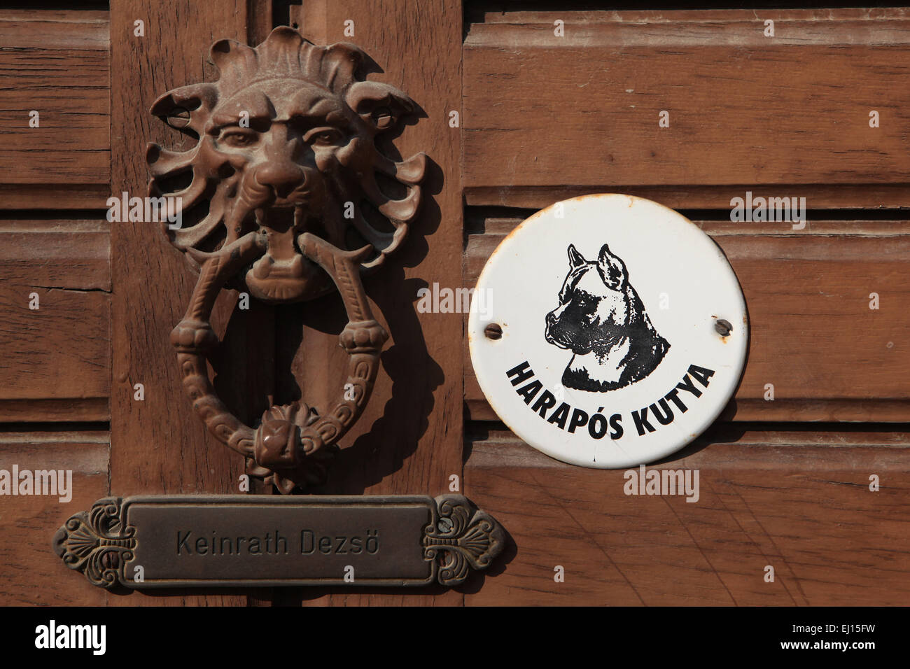 Harapos Kutya! Beware of the Dog! Warning sign and knocker at the door in Mohacs, Hungary. Stock Photo