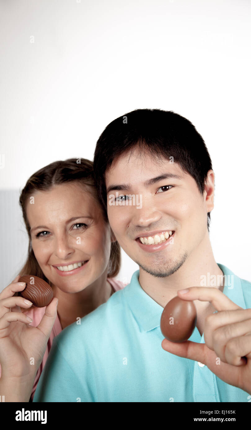 Couple holding easter eggs of chocolate Stock Photo