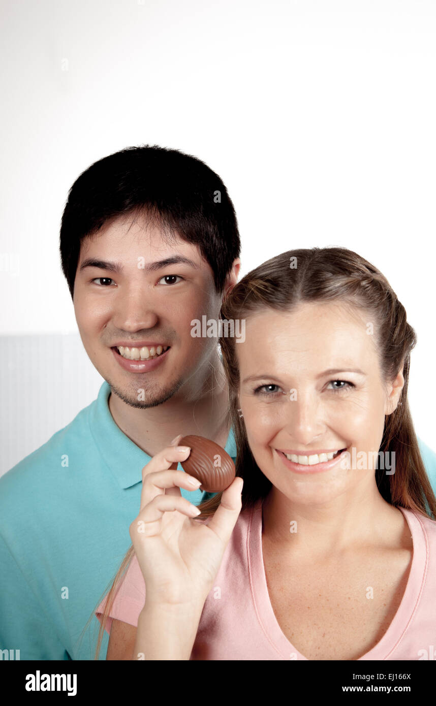 Couple holding easter eggs of chocolate Stock Photo