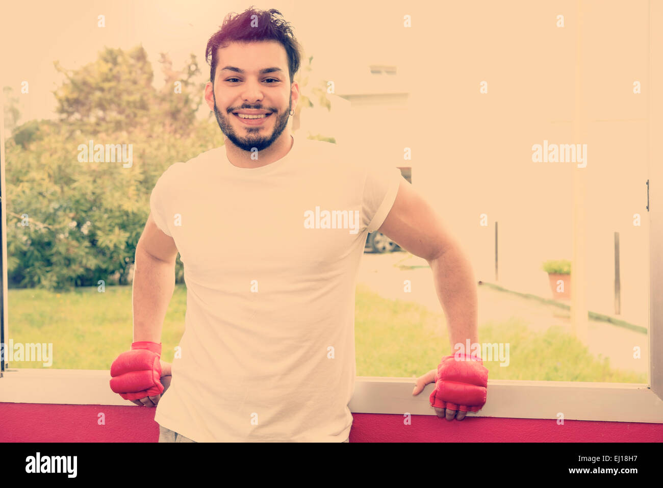 portrait of young athletic male model laughing after sport time warm tones filter applied Stock Photo