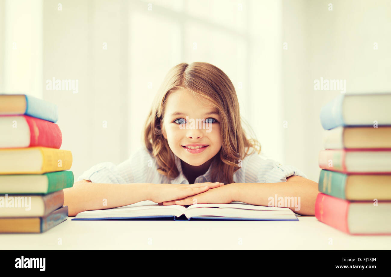 smiling little student girl with many books Stock Photo - Alamy