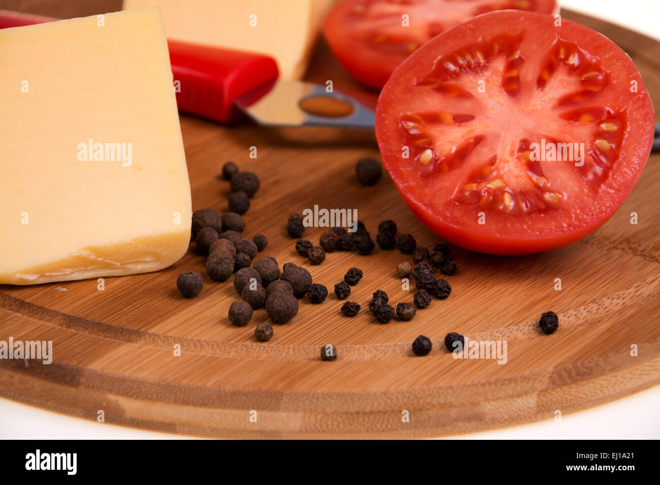 Pepper tomato and cheese on the kitchen board Stock Photo
