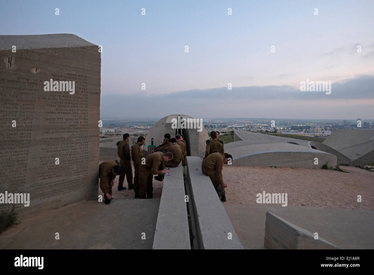 Israeli soldiers visiting the concrete monument in Brutalist architecture style design to the Negev Brigade known locally as the Andarta designed by Dani Karavan in memory of the members of the Jewish Palmach Negev Brigade who fell defending Israel during the 1948 Arab Israeli War. It is situated on a hill overlooking Beersheba also spelled Beer-Sheva the largest city in the Negev desert of southern Israel Stock Photo