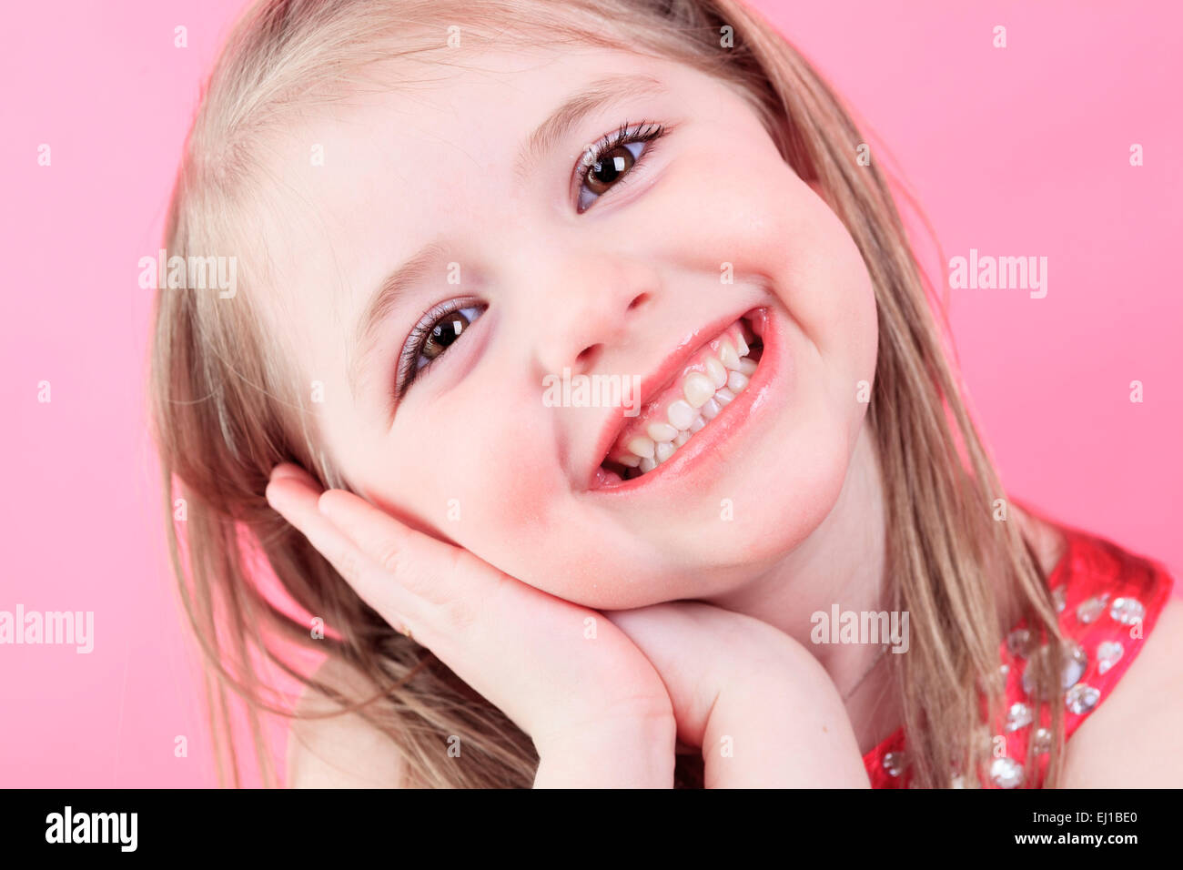 cute fashion little doll girl in pink background Stock Photo