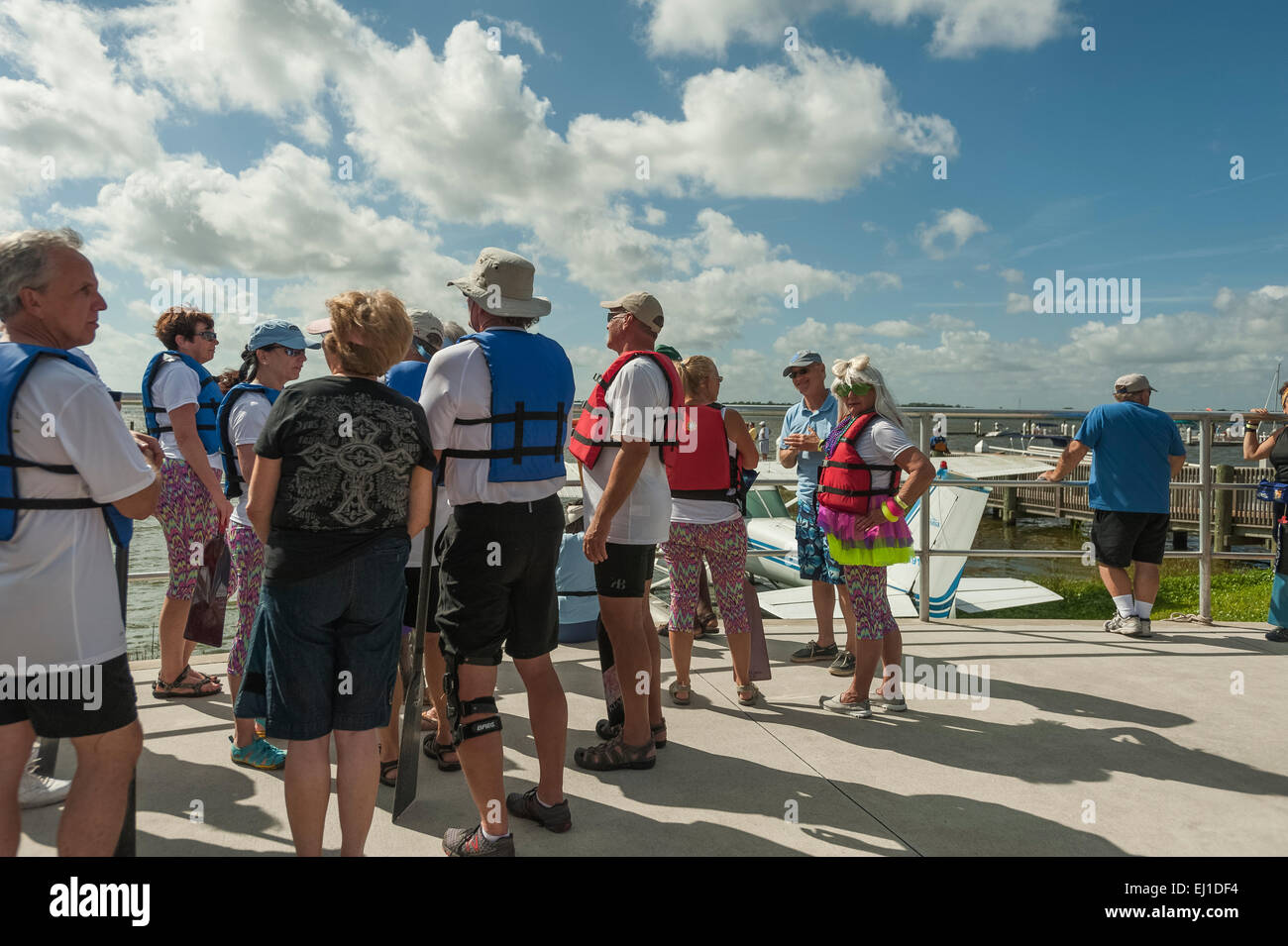 Adults wearing safety life flotation Vests devices for a boating event at Wooton Park Tavares, Florida USA Stock Photo