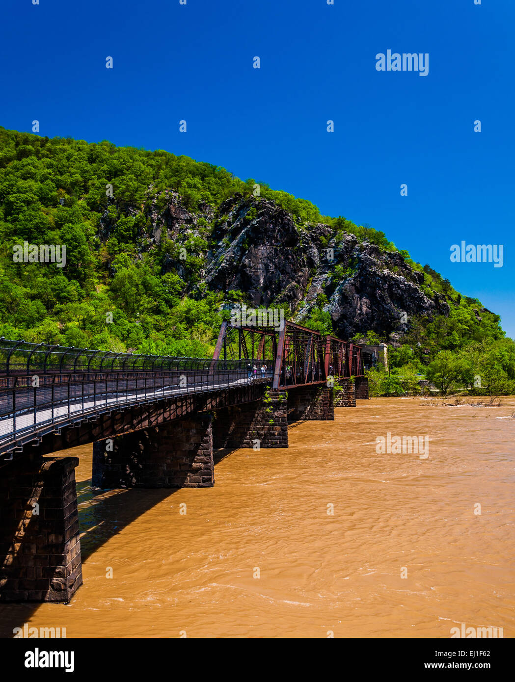 Pedestrian and train bridge across the flooded Potomac River in Harper's Ferry, West Virginia. Stock Photo