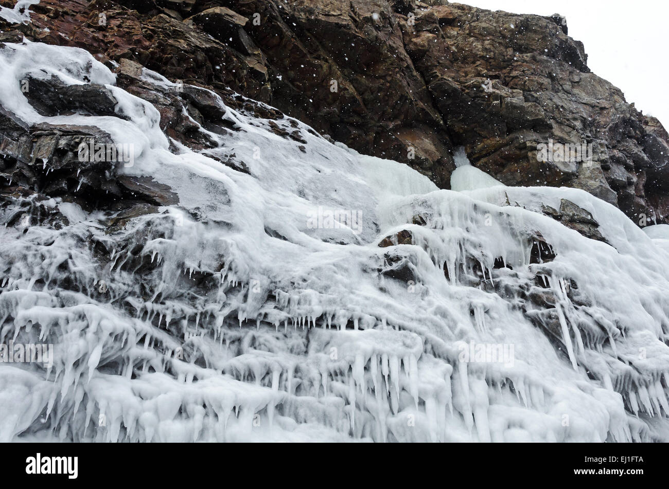 Freezing surf spray forms icicles on the face of coastal cliffs, Acadia National Park, Bar Harbor, Maine. Stock Photo