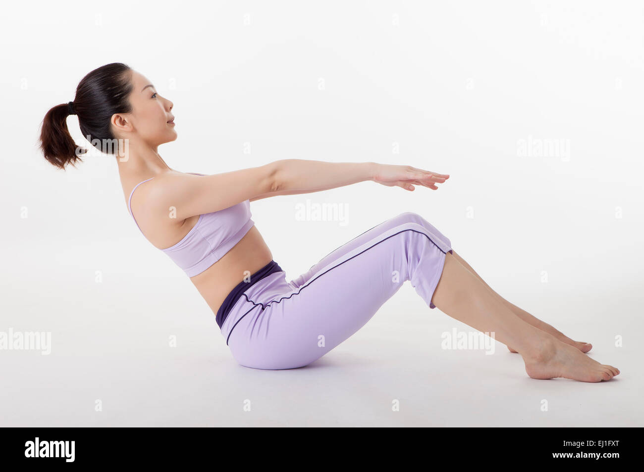 Woman practicing yoga and bending over backwards Stock Photo