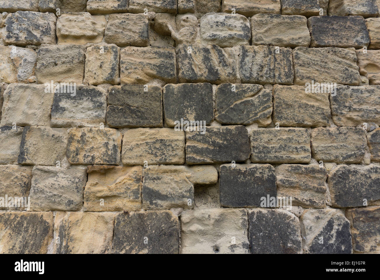 Close up detail of an old brown Bramley Fall gritstone stone wall at Kirkstall Abbey, Leeds, West Yorkshire, England Stock Photo