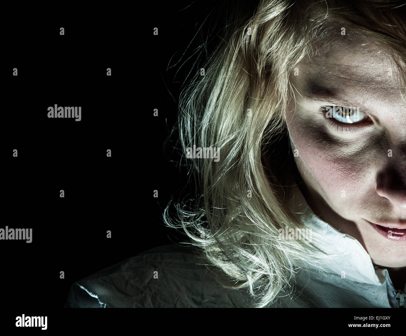 Scary Psycho Blonde Woman Looking at the Camera Stock Photo