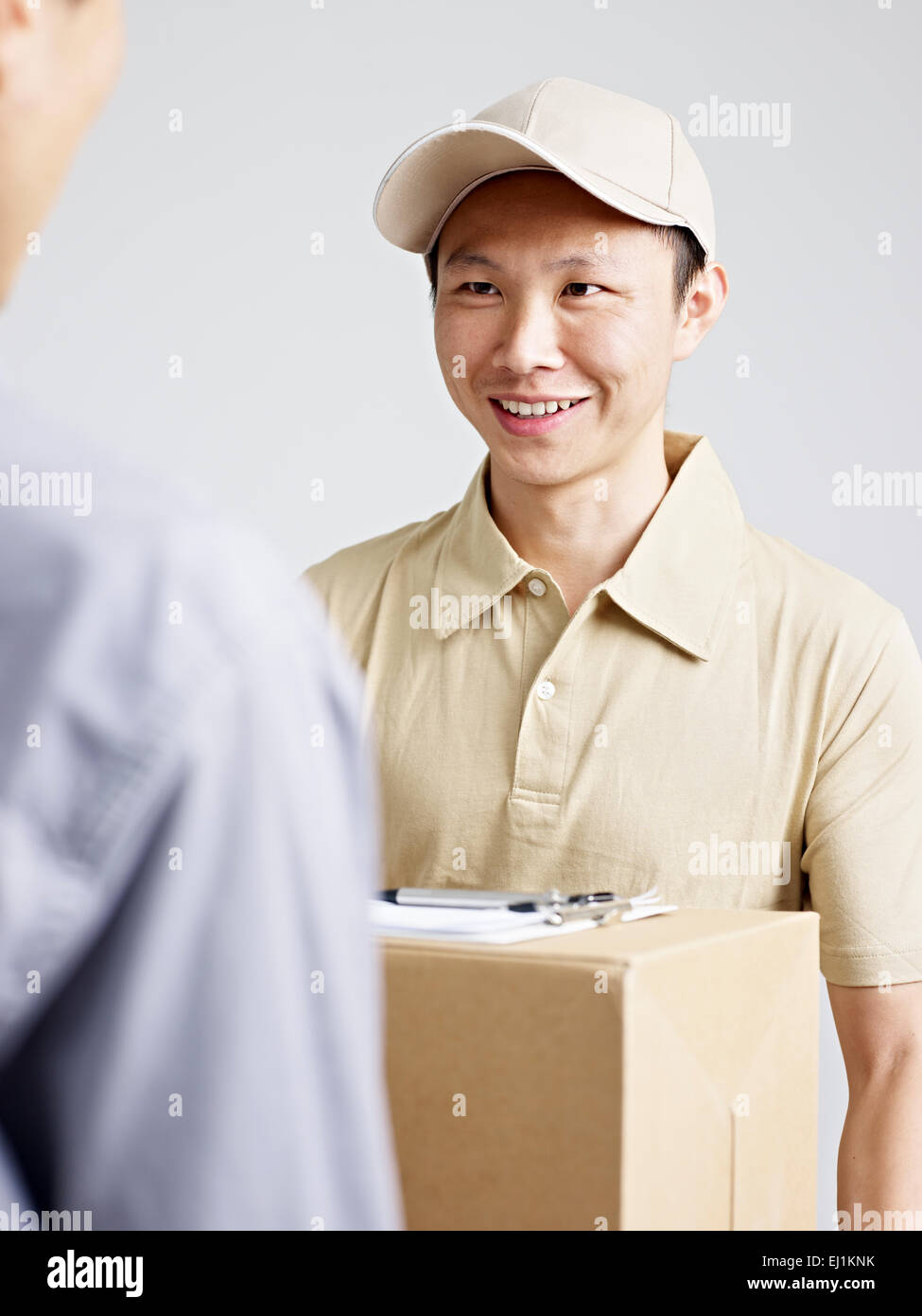 delivery man delivering a packag. Stock Photo
