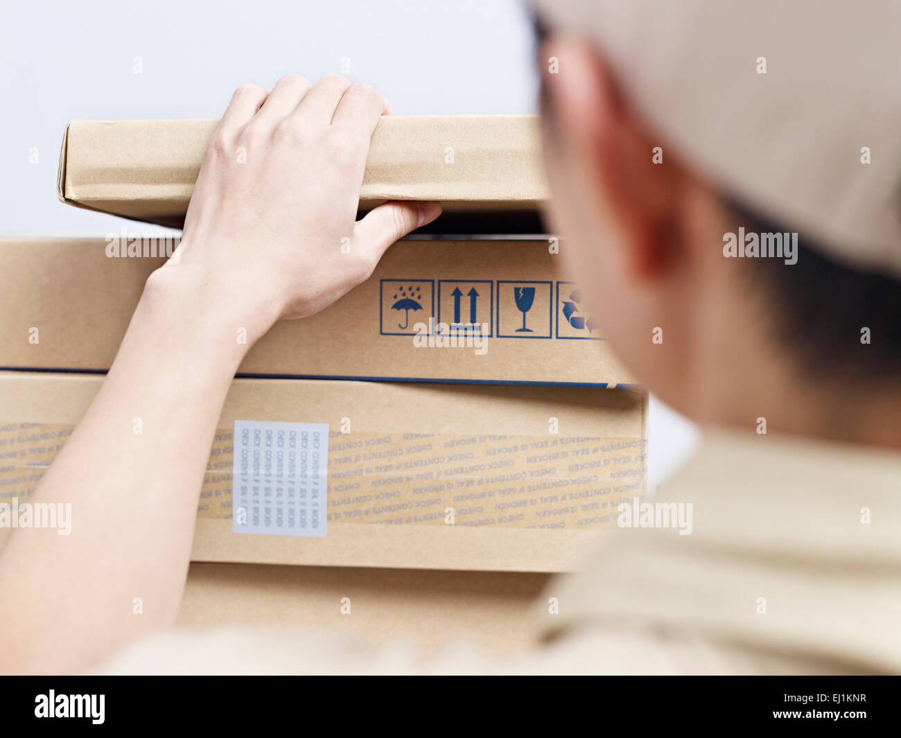 male asian delivery man checking packages to be delivered. Stock Photo