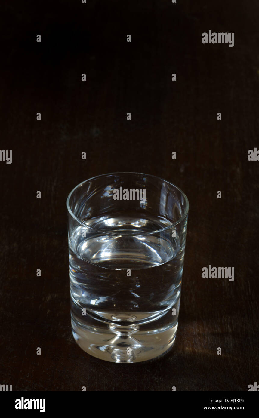 glass of water on wooden table Stock Photo - Alamy
