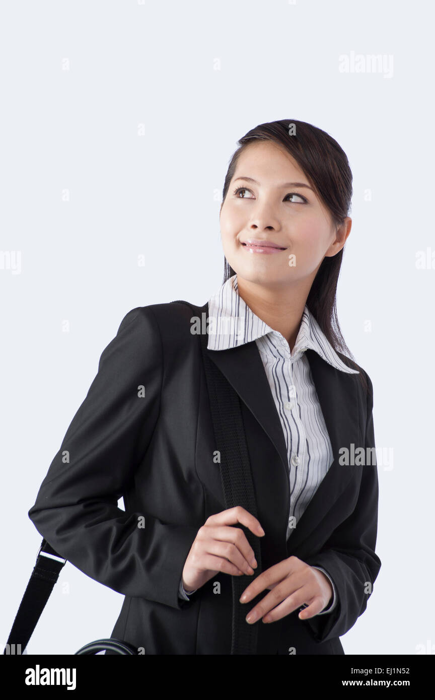 Young business woman looking away with smile Stock Photo - Alamy