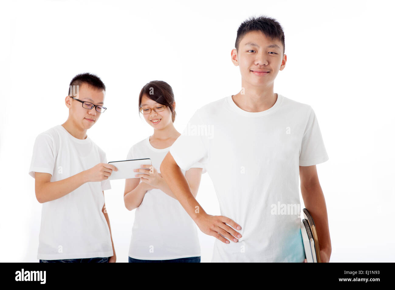 Teenager boy smiling at the camera with arms akimbo Stock Photo