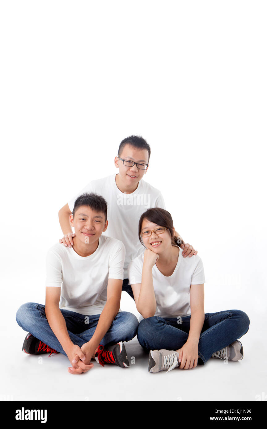 Teenagers sitting and smiling at the camera Stock Photo