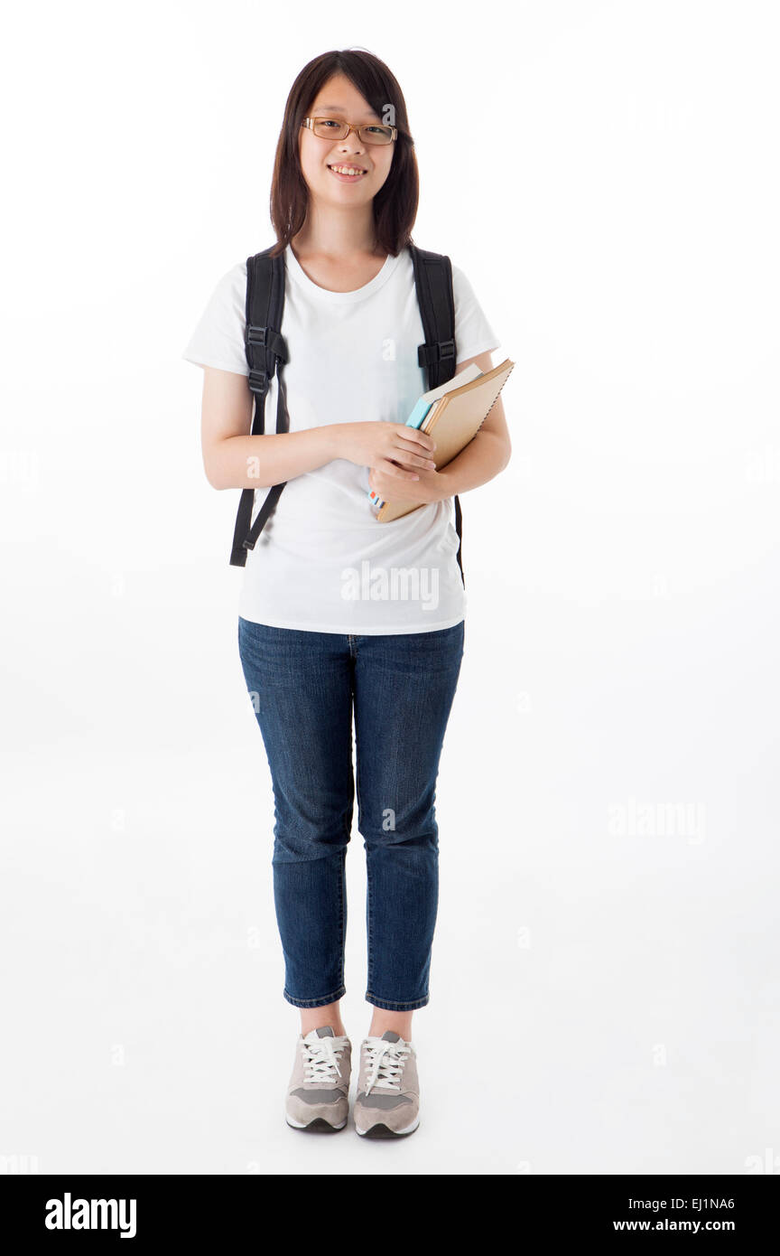 Teenage girl standing and holding books with smile Stock Photo - Alamy