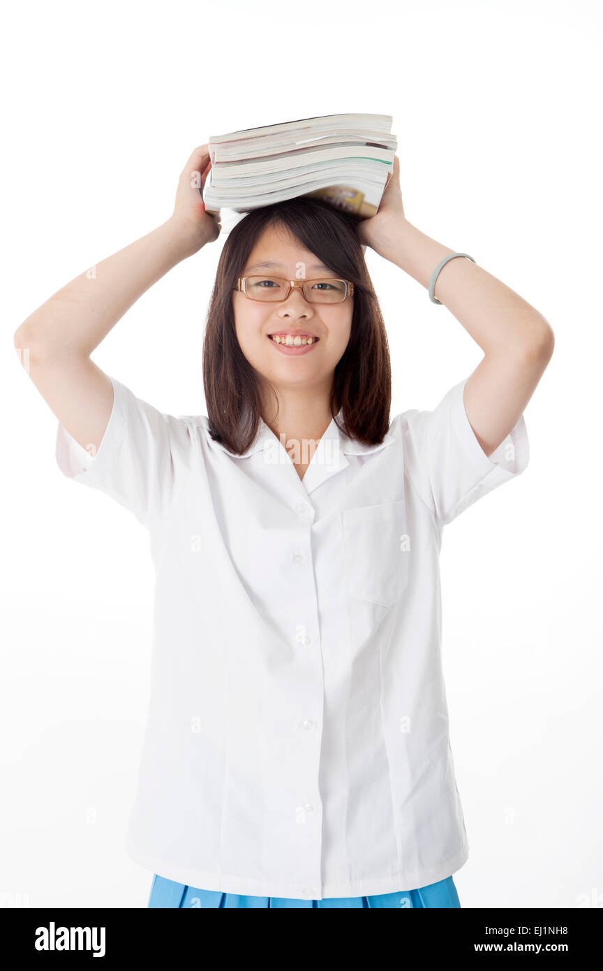 Teenage girl holding books on head and smiling at the camera Stock ...