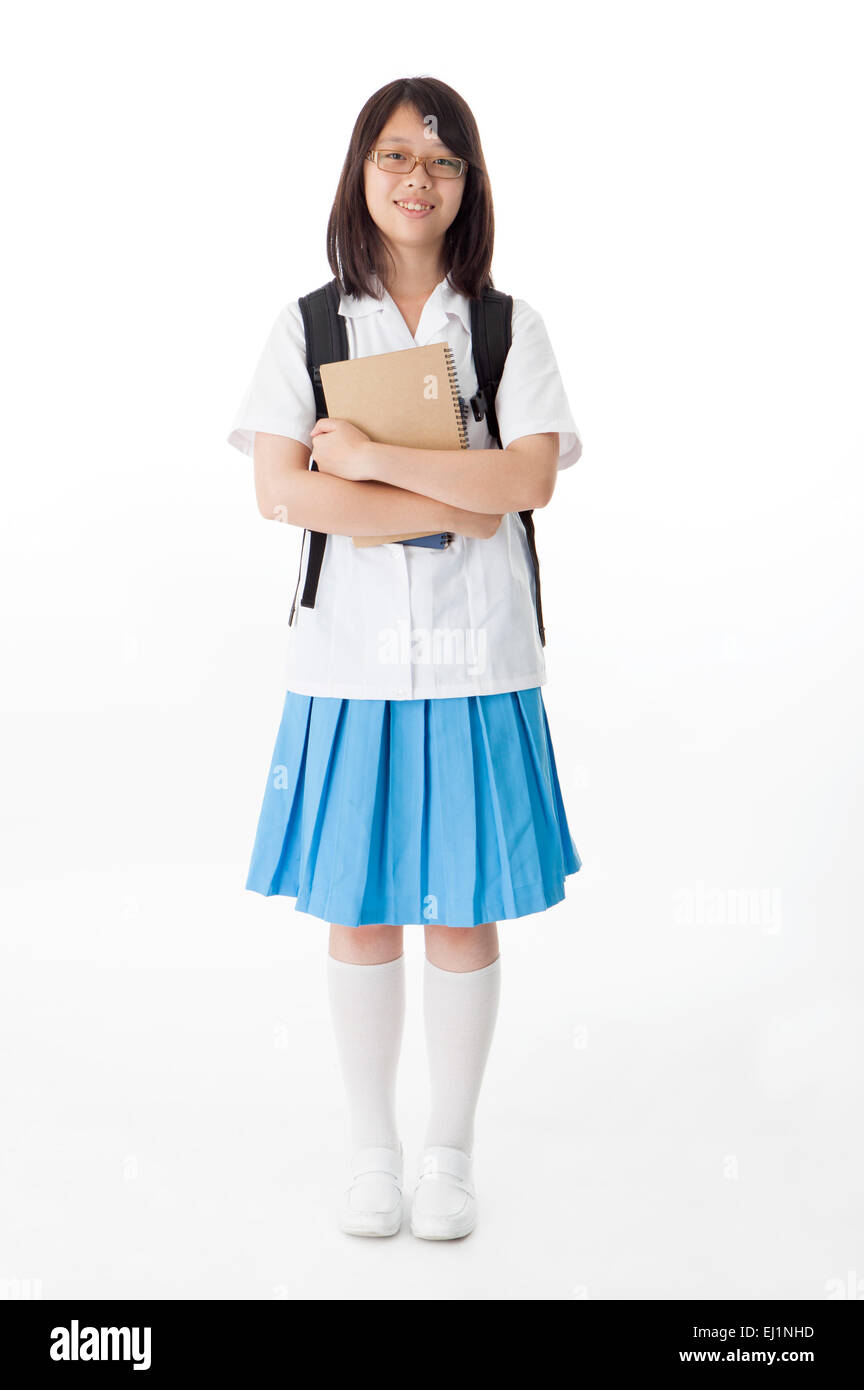 Teenage girl holding books and smiling at the camera Stock Photo - Alamy